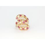 An 18ct gold hallmarked ring (stamped 21k) large fancy cluster ring set with round cut pink rubies