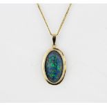 A large 9ct yellow gold (stamped 375) opal triplet set pendant (L.3cm) on a 9ct yellow gold chain,