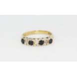 A hallmarked 9ct yellow gold ring set with sapphires and diamonds, (N.5).