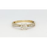 A 9ct yellow gold diamond set cluster ring with diamond set shoulders, (S), approx. 2.2gr.