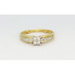 A yellow and white metal (tested minimum 9ct gold) solitaire ring set with princess cut diamonds and