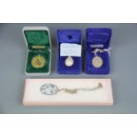 Two silver necklaces together with a Franklin mint porcelain egg pendant and chain and a silver gilt