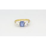 An 18ct white gold (stamped 18ct) ring set with a scissor cut sapphire and two old brilliant cut
