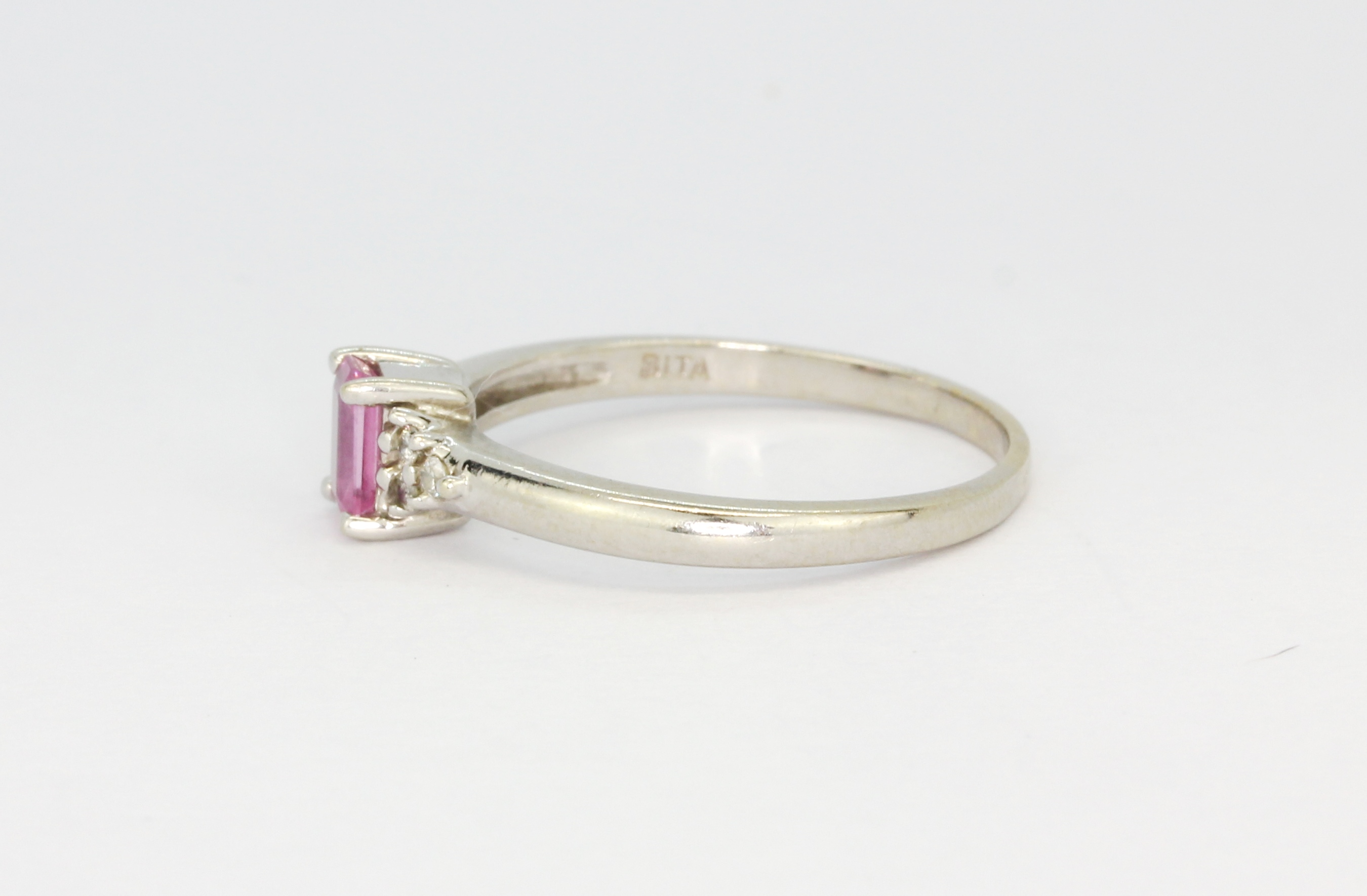 A 14ct white gold (stamped 14k) solitaire ring set with an emerald cut pink sapphire and diamond set - Image 2 of 2