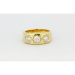 A gentleman's 9ct yellow gold (stamped 9k) ring set with three brilliant cut diamonds, (R.5),