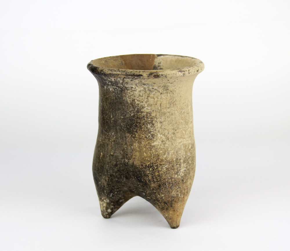 A Neolithic (10,000–4,500 BCE) clay fire pot, H. 14cm, Dia. 10cm. Some museum style restoration.