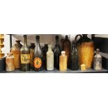 A group of antique stoneware and glass bottles.