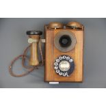 A mahogany cased wall mounted telephone, H. 24cm.