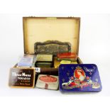 A box of old playing cards and vintage tins.