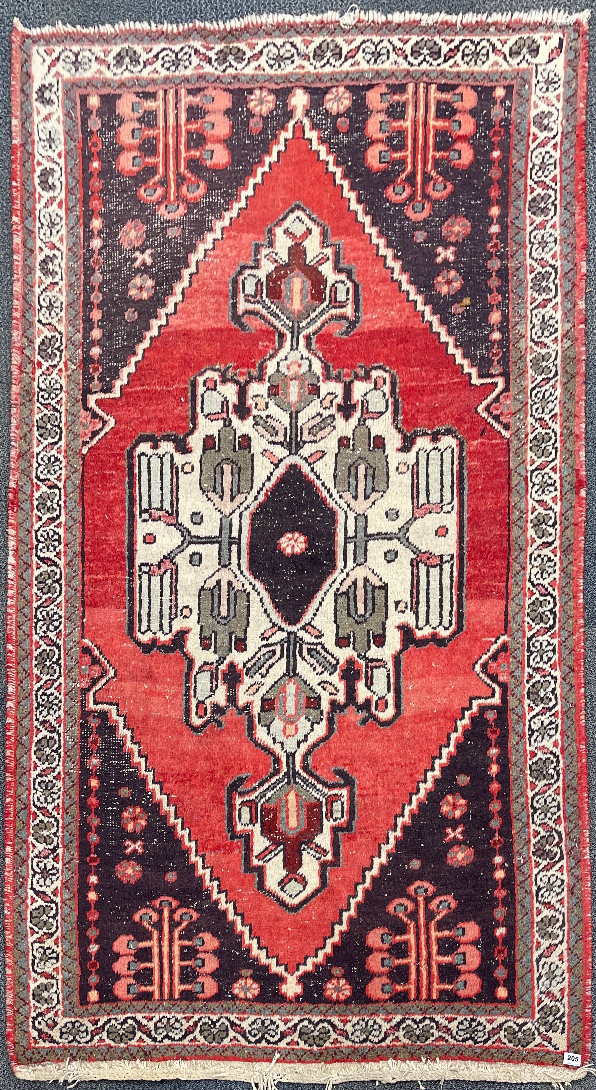 An antique Eastern hand woven wool rug, 193 x 135cm.