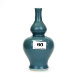 A Chinese pale blue glazed porcelain gourd vase, H. 18cm. Six character mark to base Yong Cheng (