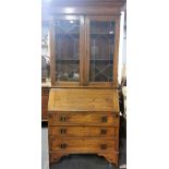 A 19th Century inlaid oak Arts and Crafts bureau bookcase with leaded glass doors W. 91cm H. 205cm.