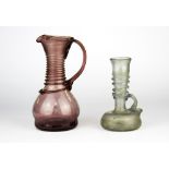 An early amethyst glass jug (possibly Dutch), H. 17cm. together with a Roman glass vase, repaired.