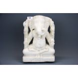 A lovely carved marble figure of the elephant god Ganesh seated in lotus position with four hands