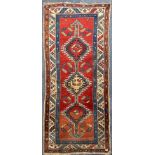 An antique Turkish hand woven wool rug, 235 x 105cm.
