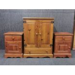 A pair of pine bedside cabinets together with a larger pine cabinet, bedside tables 63 x 46 x 40cm.