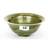 A Chinese olive green glazed porcelain rice bowl with centre incised decoration of a peony, Dia.