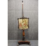 A William IV carved rosewood pole screen with original fine tapestry shield, H. 145cm.