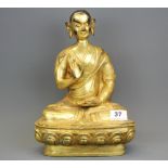 A Tibetan gilt bronze figure of a seated Buddhist Deity, H. 31cm.