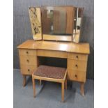 A 1960's light wood dressing table and stool by Frederick Restall Ltd, W. 116cm overall H. 139cm.