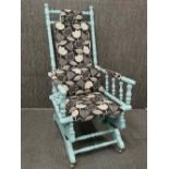 An American re-upholstered and re-finished rocking chair, H. 111cm.