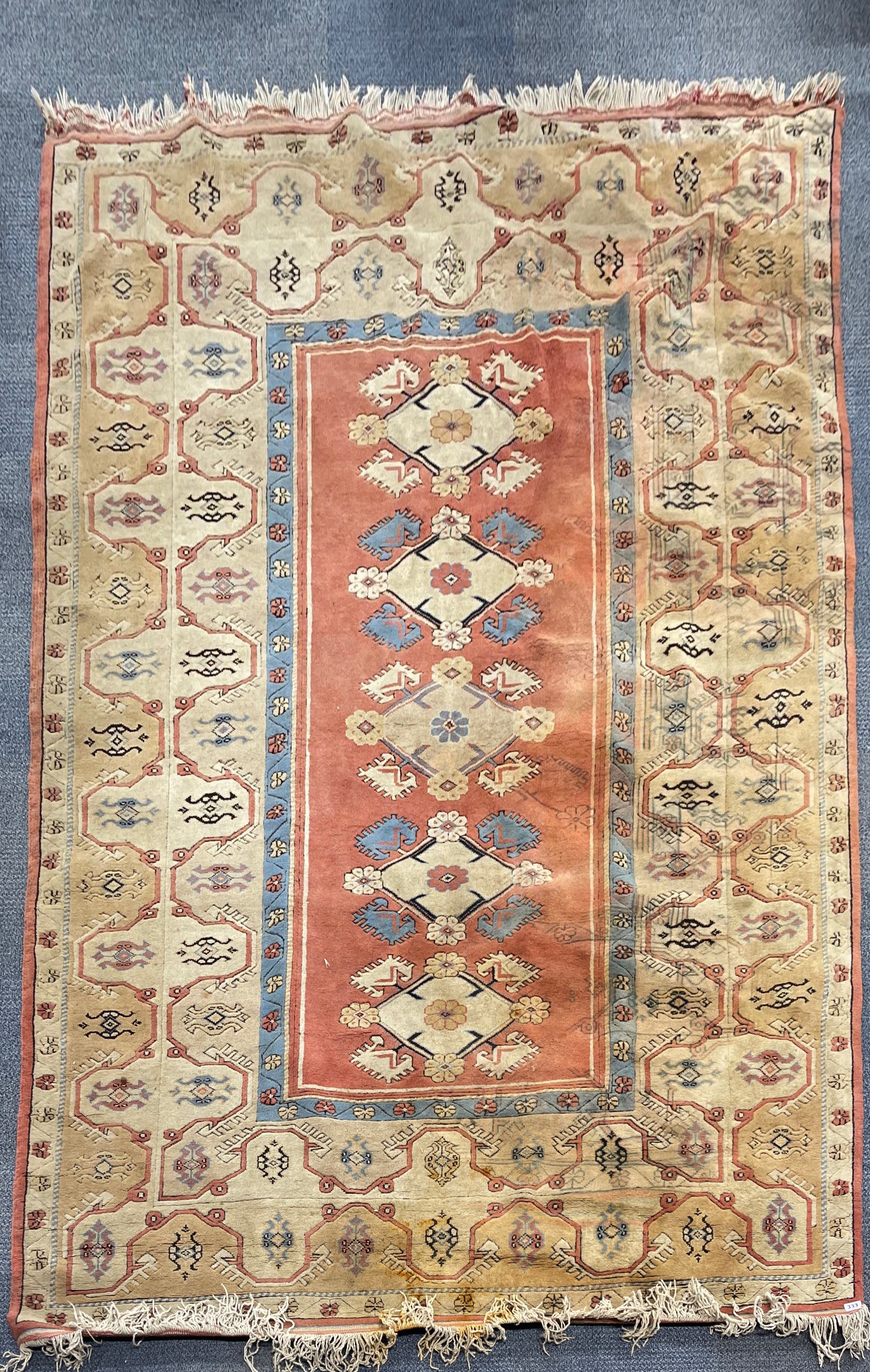 A hand woven Turkish wool rug, 212 x 300cm.