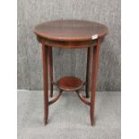 An inlaid circular Edwardian mahogany side table, H. 72cm W. 53cm.