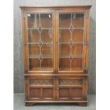 A leaded glass display cabinet, 161 x 108 x 38cm.