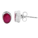A pair of 925 silver stud earrings set with oval cut rubies, L. 0.7cm.