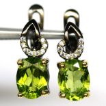 A pair of 925 silver earrings set with oval cut peridot and white stones, L. 1.5cm.