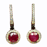 A pair of 925 silver earrings set with round cut rubies and white stones, L. 2.7cm.