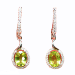 A pair of 925 silver drop earrings set with oval cut peridots and white stones, L. 3.5cm.