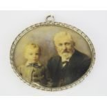 A white metal mounted hand painted portrait miniature of an elderly gentlemen and a boy, W. 8.5cm.