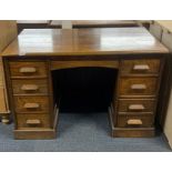 A 1930's oak kneehole desk, 113 x 60 x 74cm.