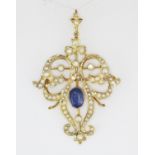 An Edwardian 9ct yellow gold (stamped 9ct) brooch / pendant set with an oval cut sapphire and