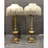 A pair of impressive gilt brass lamps with beaded shades, H. 123cm.