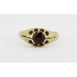 A hallmarked 9ct yellow gold ring set with a round cut garnet, (Q).