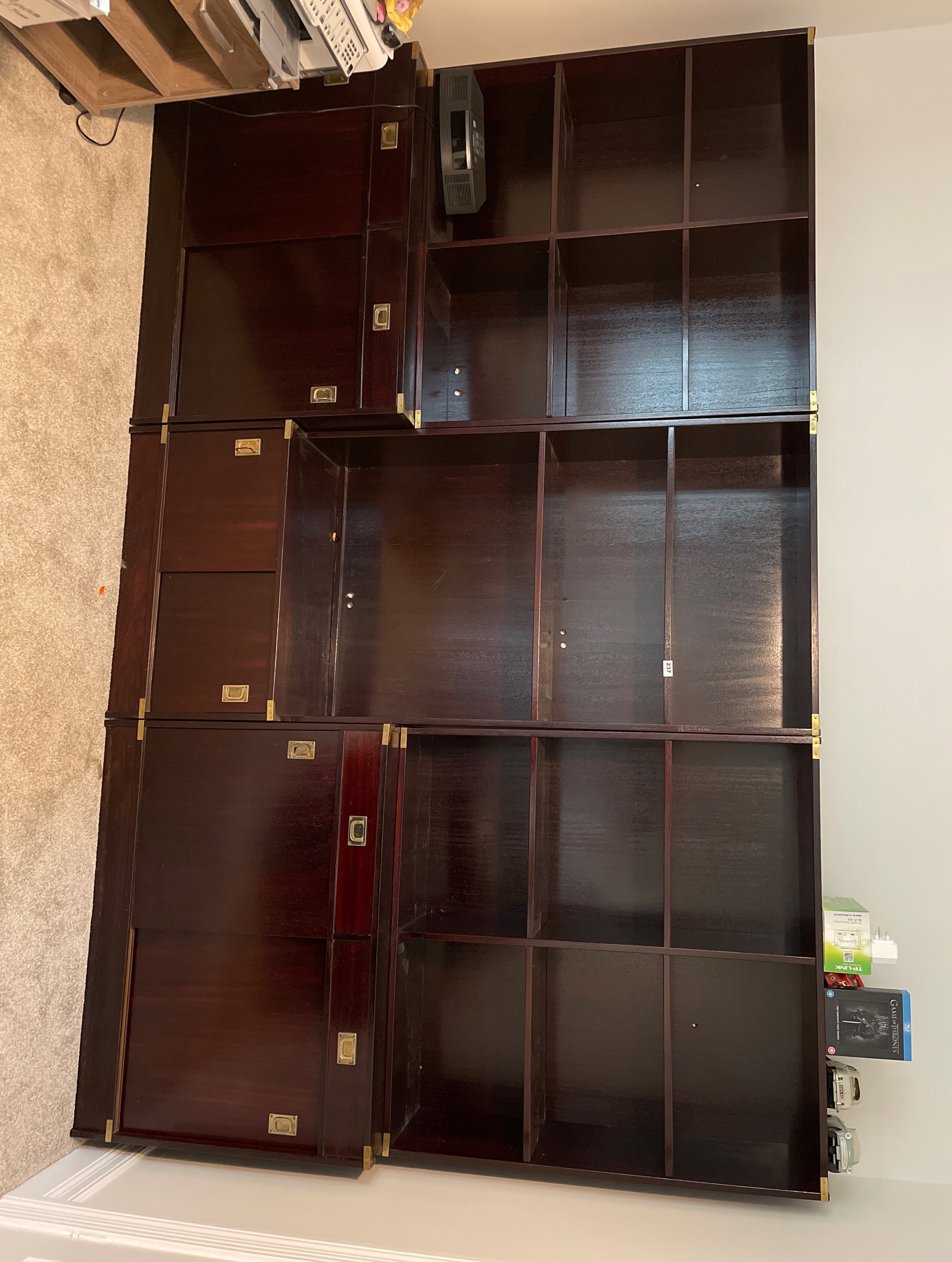 A set of three brass mounted military style library bookcase units, overall W. 279cm. H. 176cm.