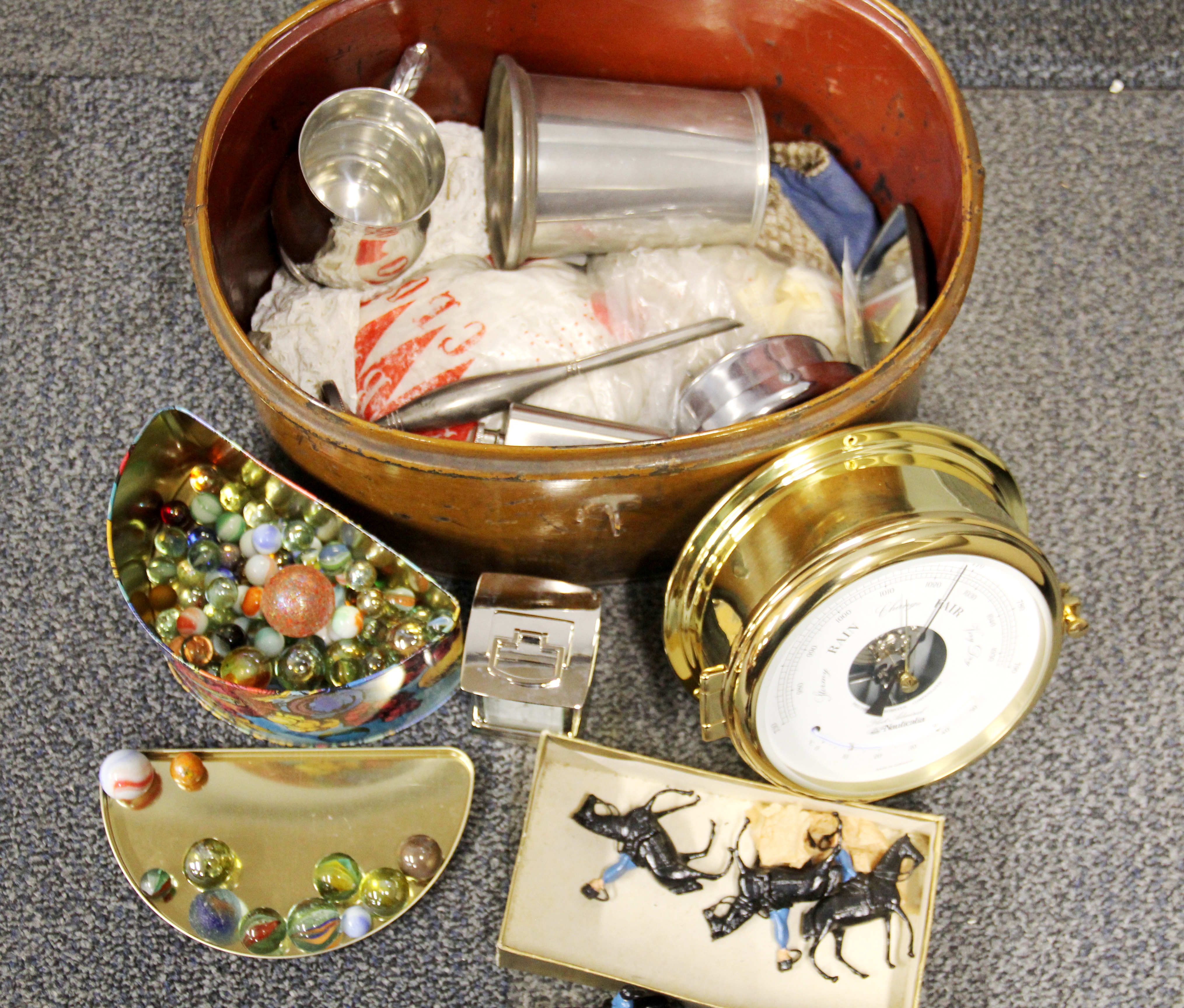 A metal hat box and contents.