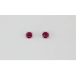 A pair of 925 silver white gold stud earrings set with rubies, Dia. 0.4cm.