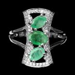 A 925 silver ring set with three oval cut emeralds and white stones, (S).