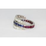 A white metal (tested 18ct gold) metamorphic ring set with sapphires, rubies and two rows of