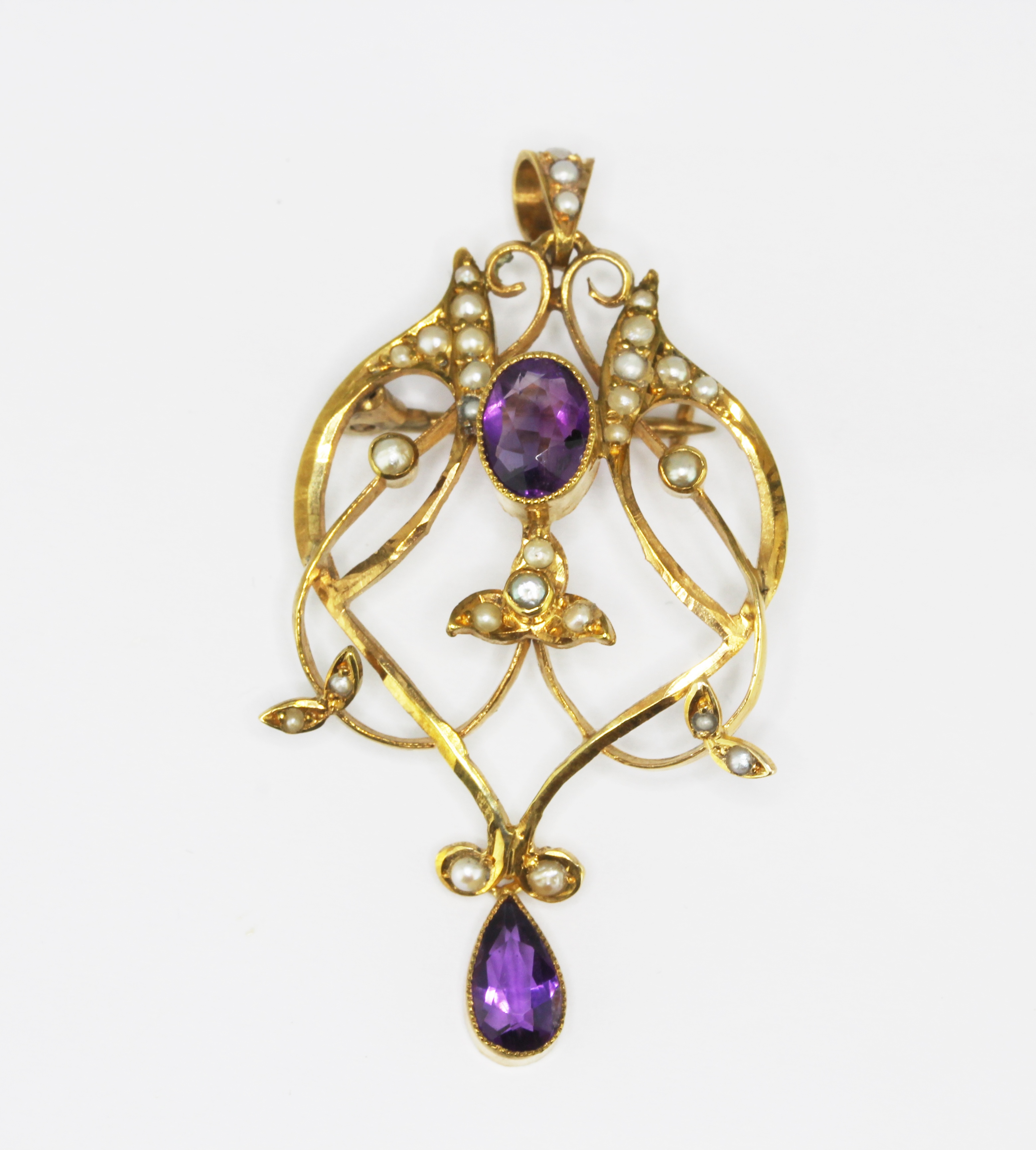 An Edwardian 9ct yellow gold (stamped 9ct) brooch / pendant set with amethysts and split pearls,