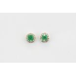 A pair of 9ct yellow gold (stamped 9K) halo earrings set with a round cut emerald surrounded by