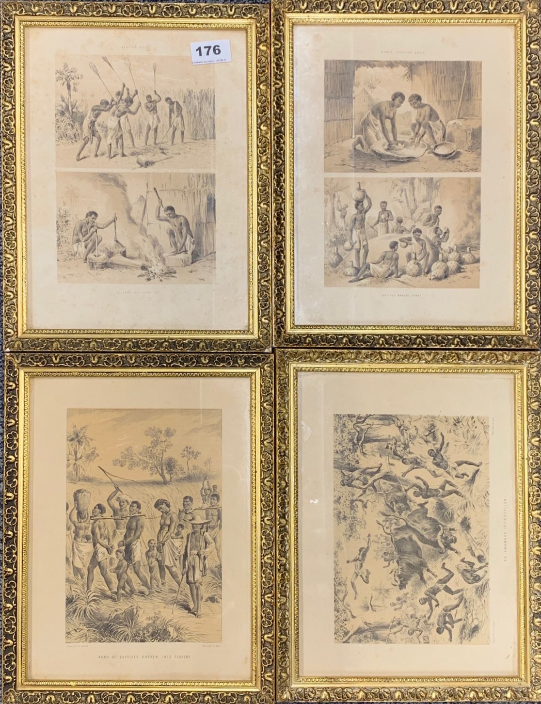 A set of four gilt framed early prints showing African tribal life and capturing slaves, frame