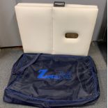 A folding Zita M therapy bed and case.