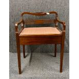 A 1920's walnut piano stool.