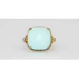 A 9ct yellow gold ring set with turquoise and diamond set shoulders, (L.5).