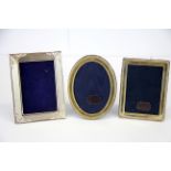 Two small hallmarked silver photo frames, H. 10cm. together with a 925 silver photo frame.