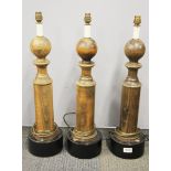 Three turned wood and painted metal based gentleman's club table lamps, H. 64cm.